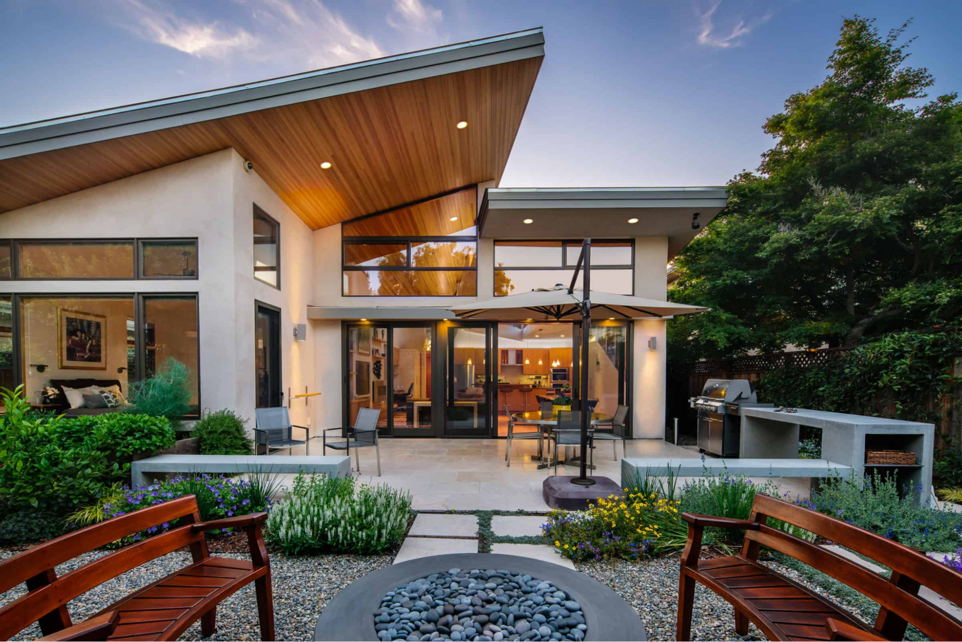 Glass walls at the back of the house connect to the outdoors