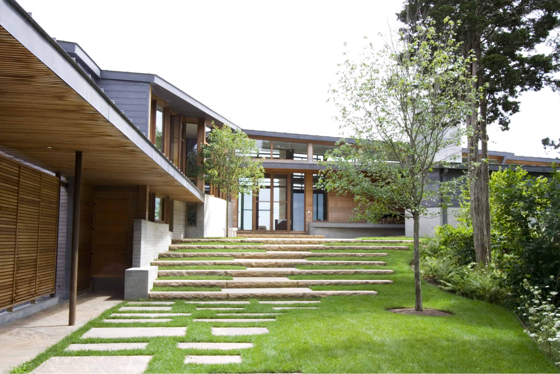 Long granite blocks ascend to the entry of the house