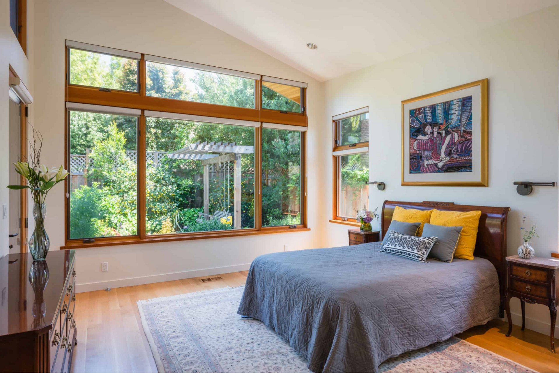 The master bedroom has a sloped ceiling and private garden views