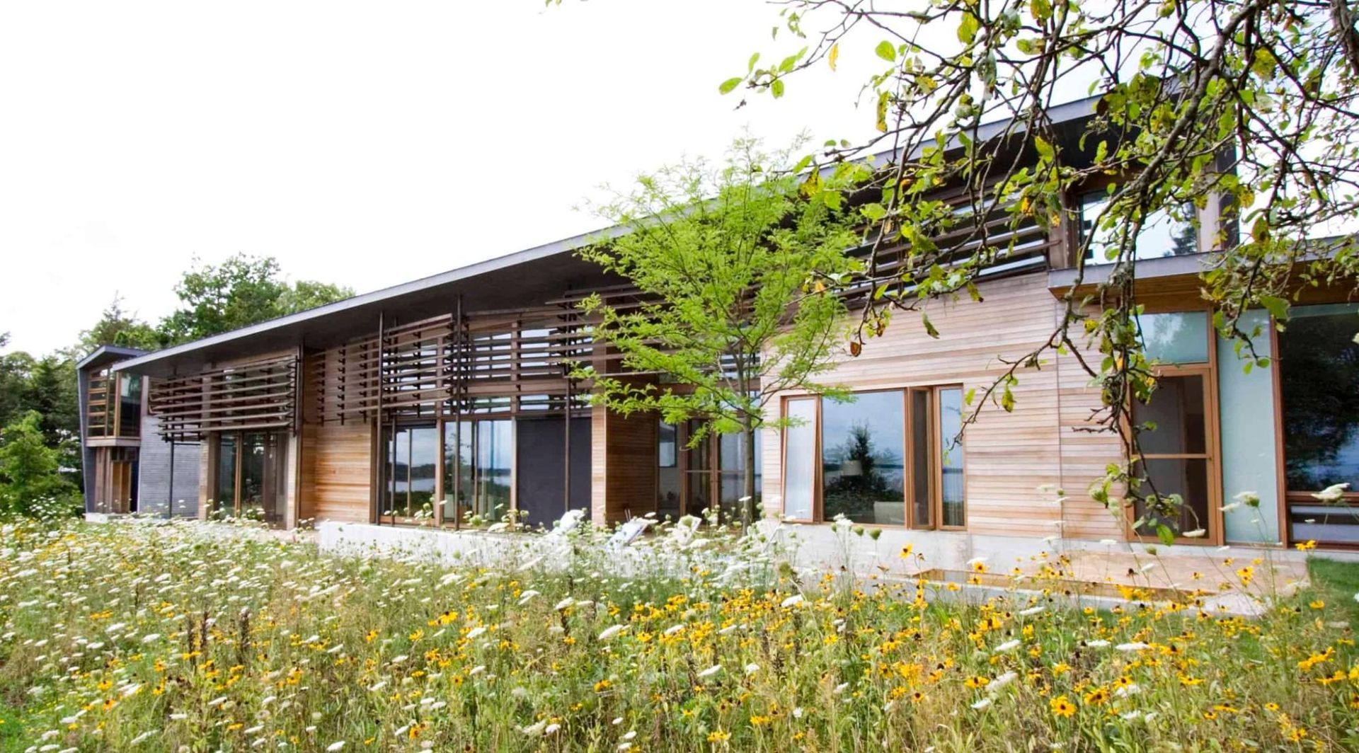 Walls of windows shape the waterside of the house