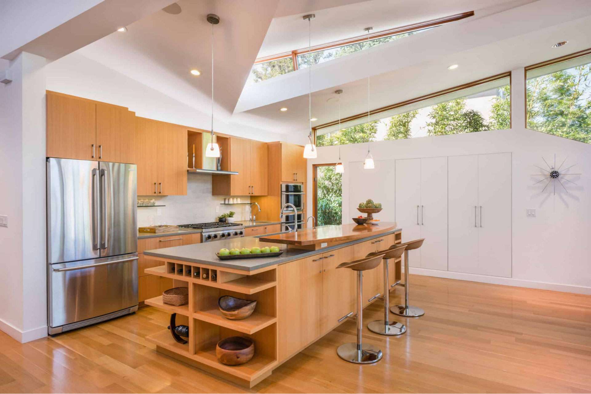 Angled skylight and windows illuminate the centrally located kitchen