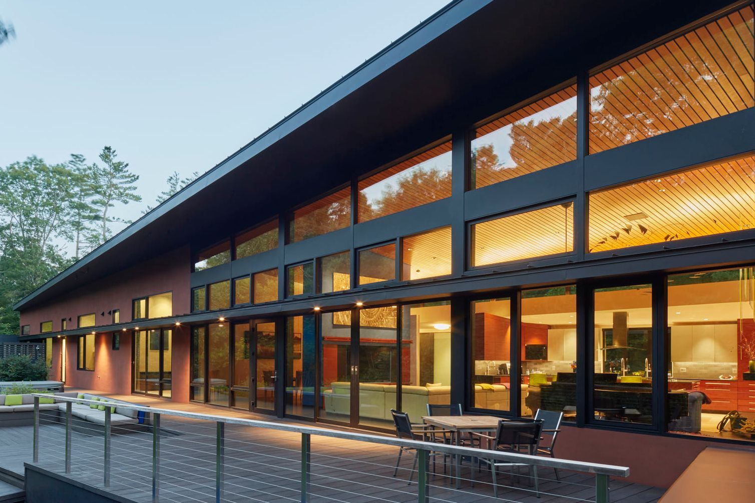 Windows of a light-filled modern house at dusk