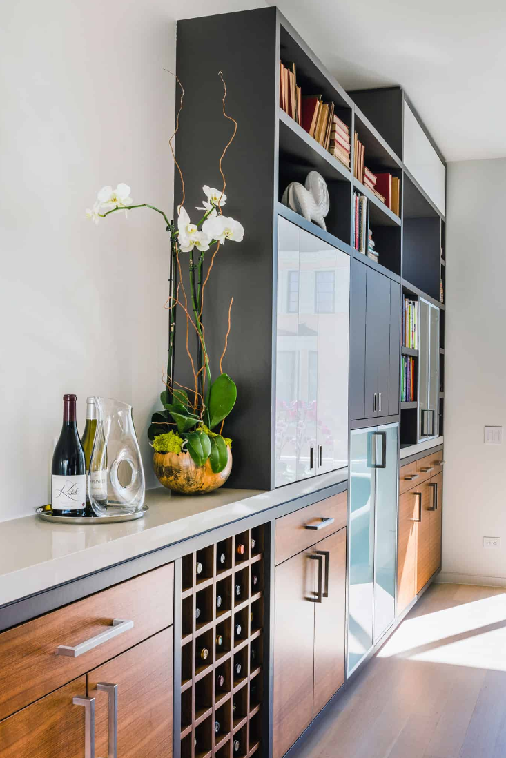 The composition of the kitchen cabinet materials and layout are elegantly varied