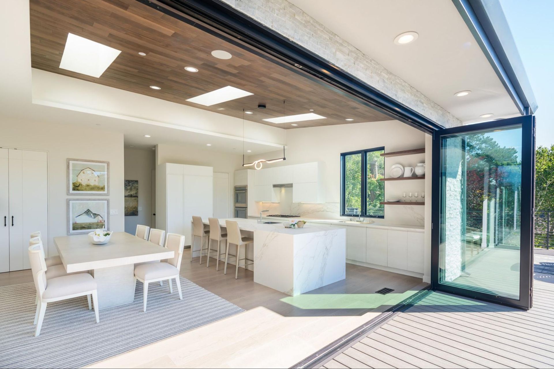 The kitchen and dining room open completely to the deck 