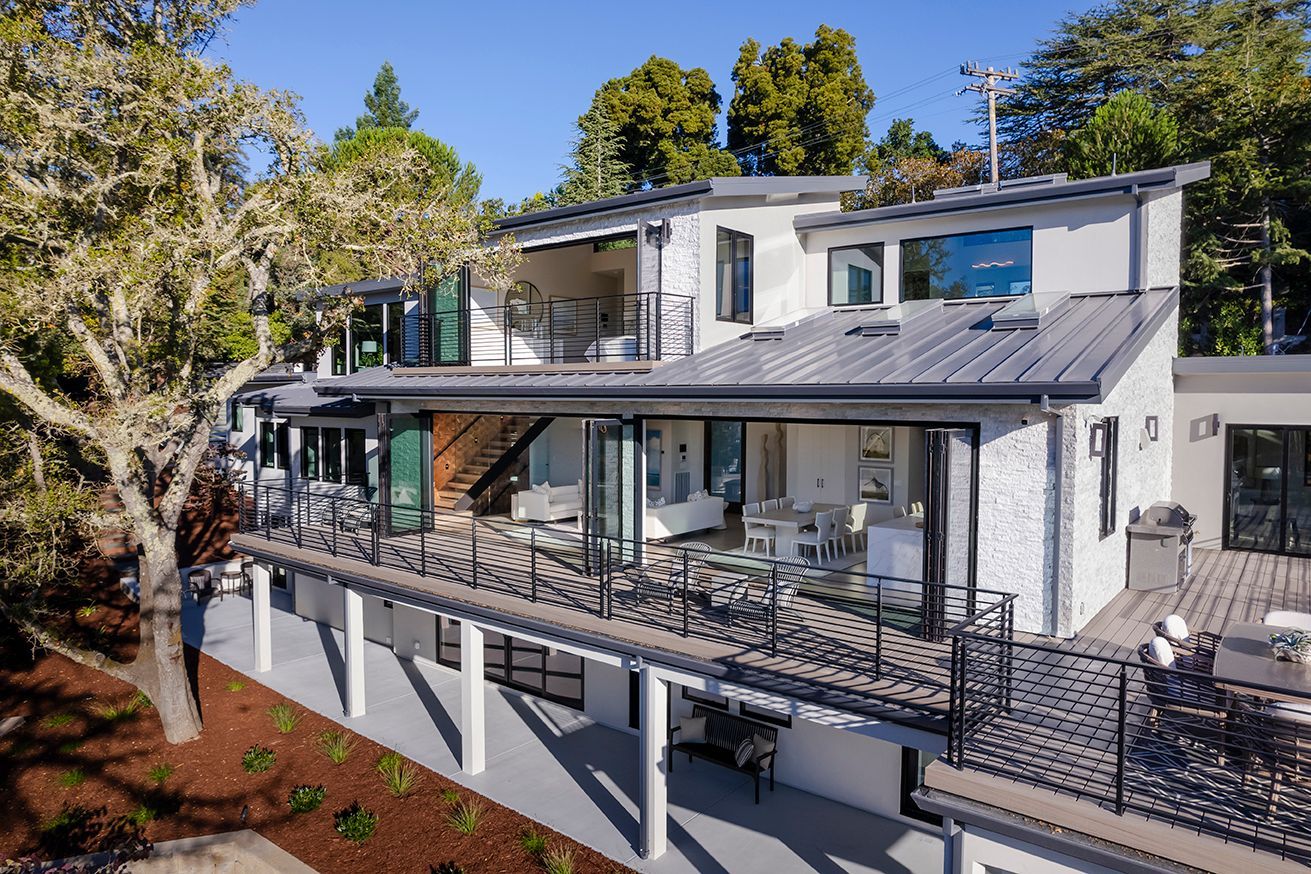 The back of the house opens to decks on three levels