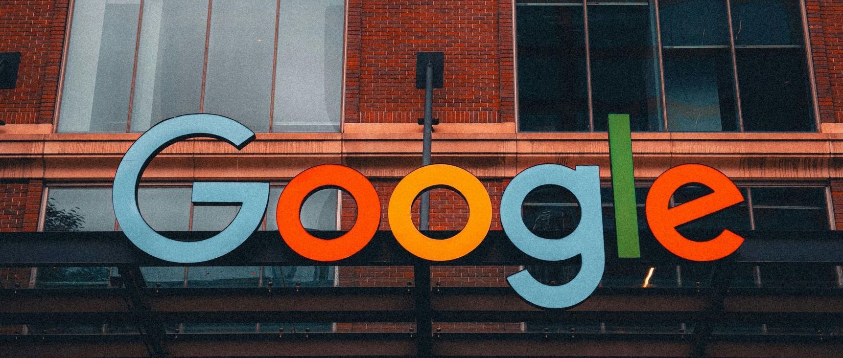 A google sign is on the side of a building.