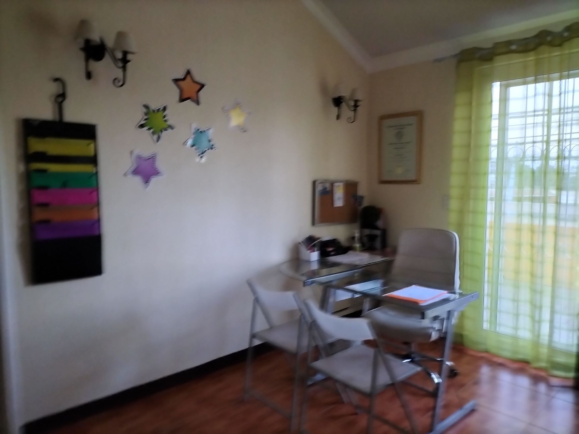 Una habitación con un escritorio y sillas y estrellas en la pared.