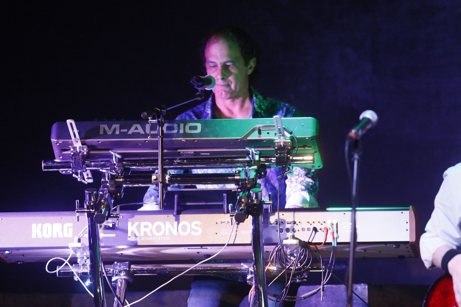 A man is playing a keyboard that says kronos on it