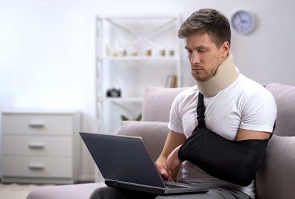 Injured Man Using Laptop — Prescott, AZ — Becke & Olson, PLLC
