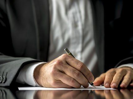 Man Signing a Document — Prescott, AZ — Becke & Olson, PLLC