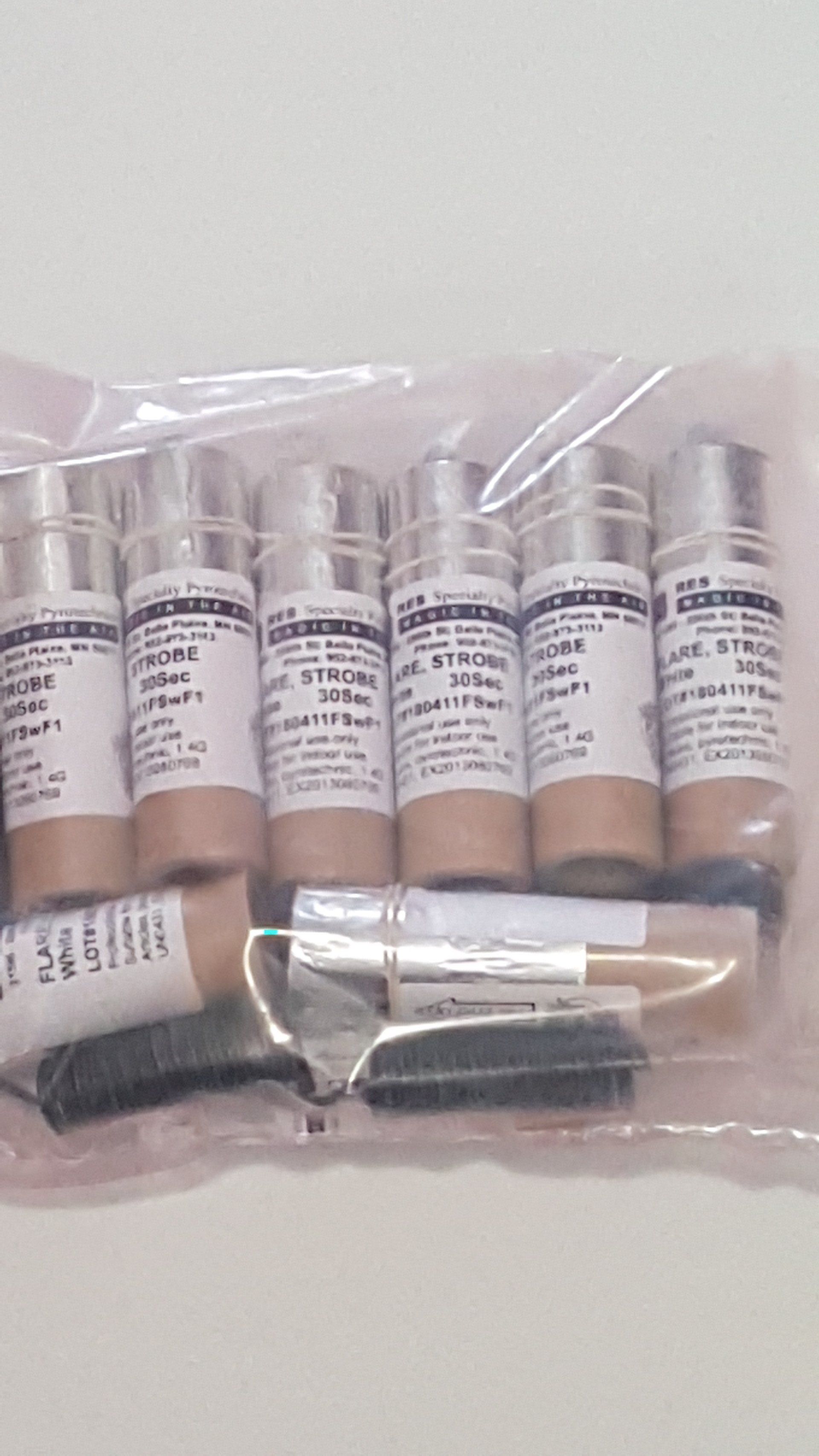 A plastic bag filled with bottles of lotion and a brush.