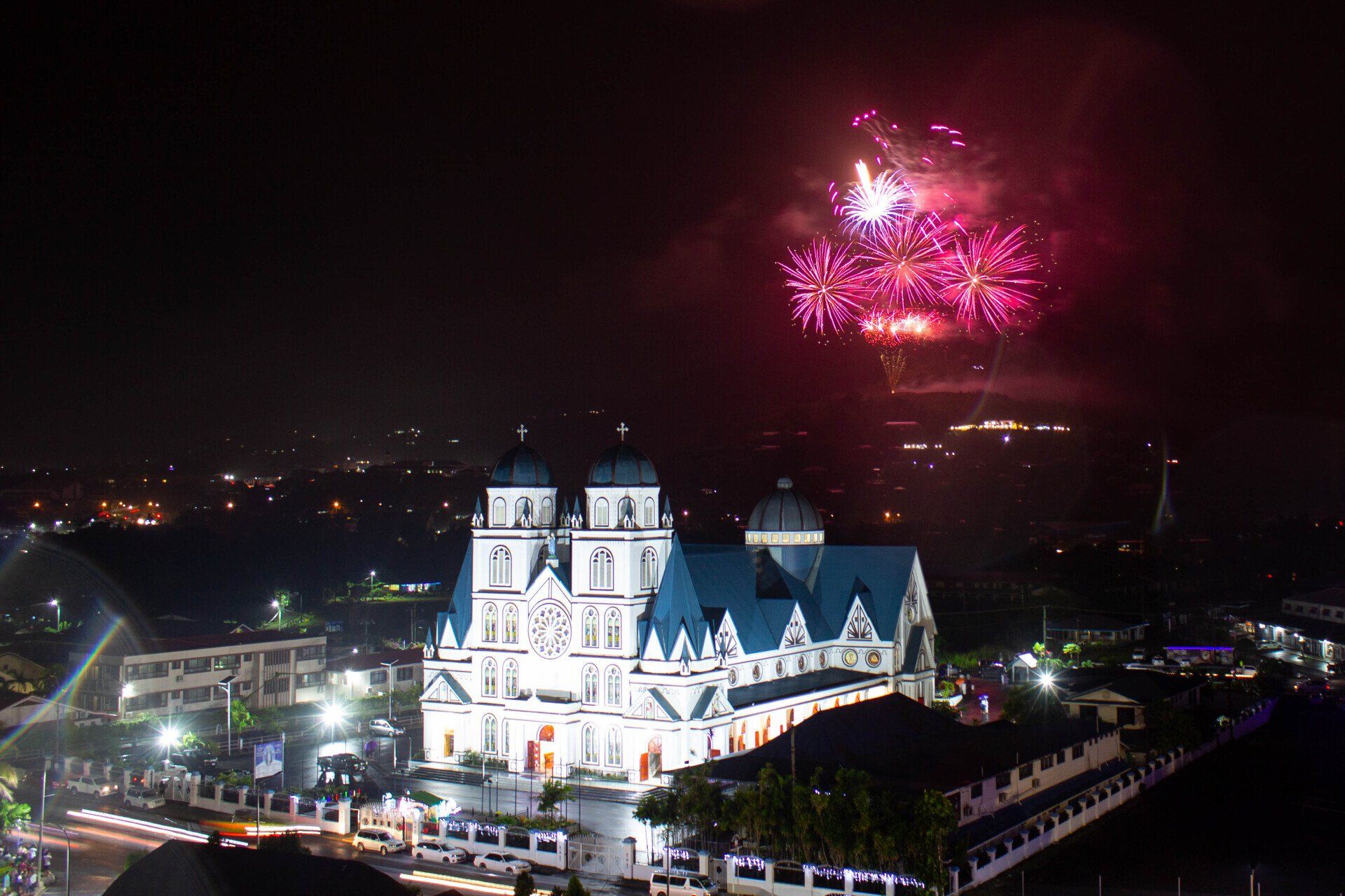 Fireworks are displayed over a church at night in Samoa