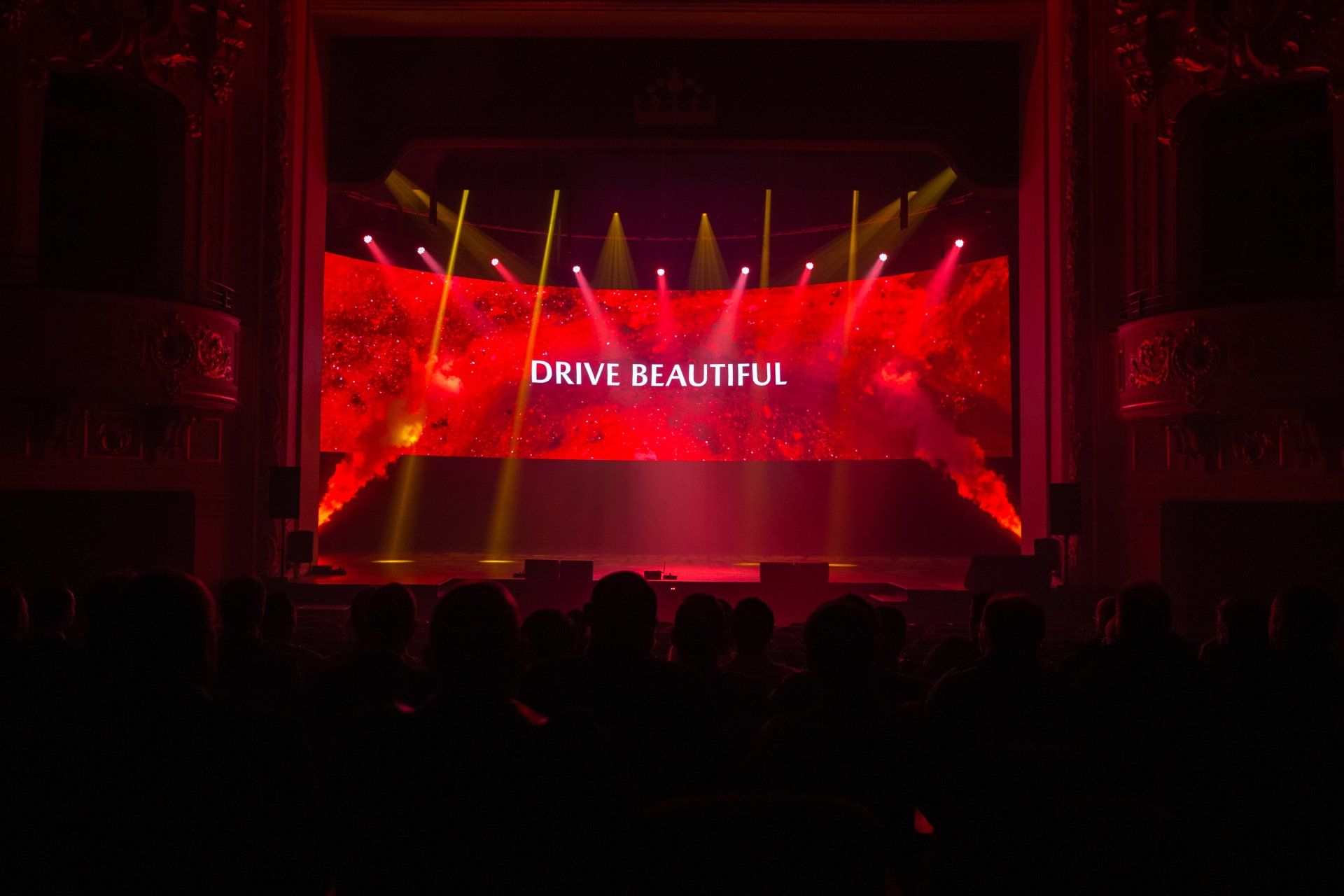 A large screen with the words drive beautiful on it