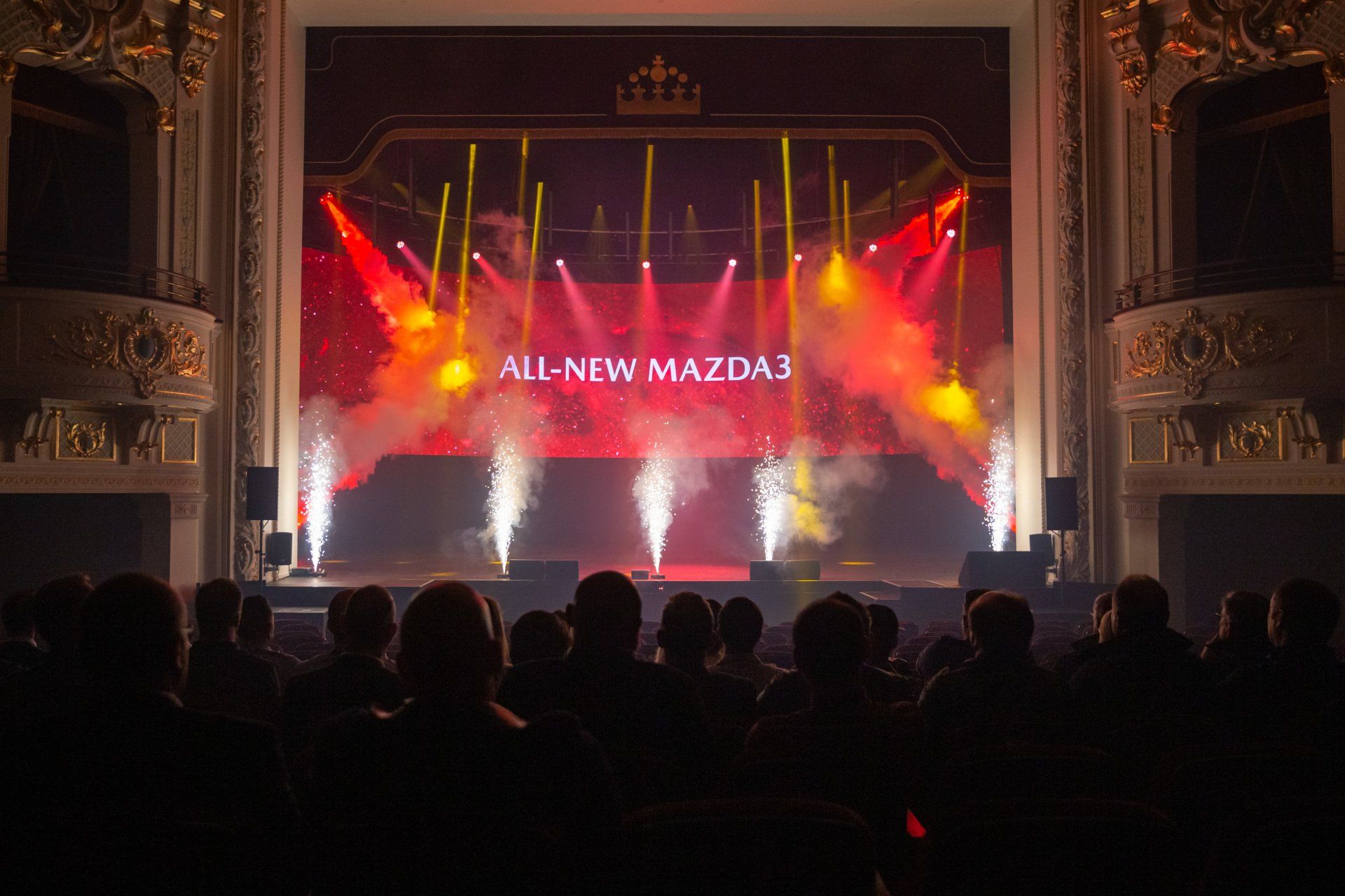 A crowd of people are watching a concert in a theater.