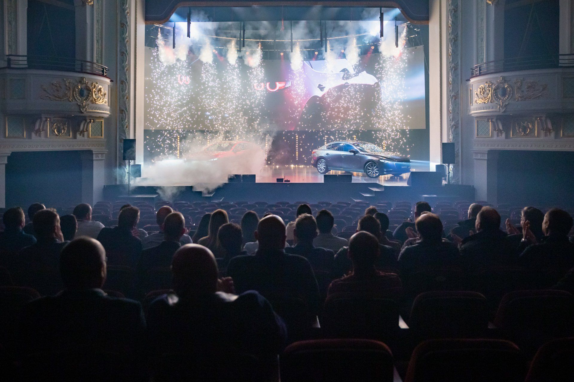 A crowd of people are watching a concert in a theater.