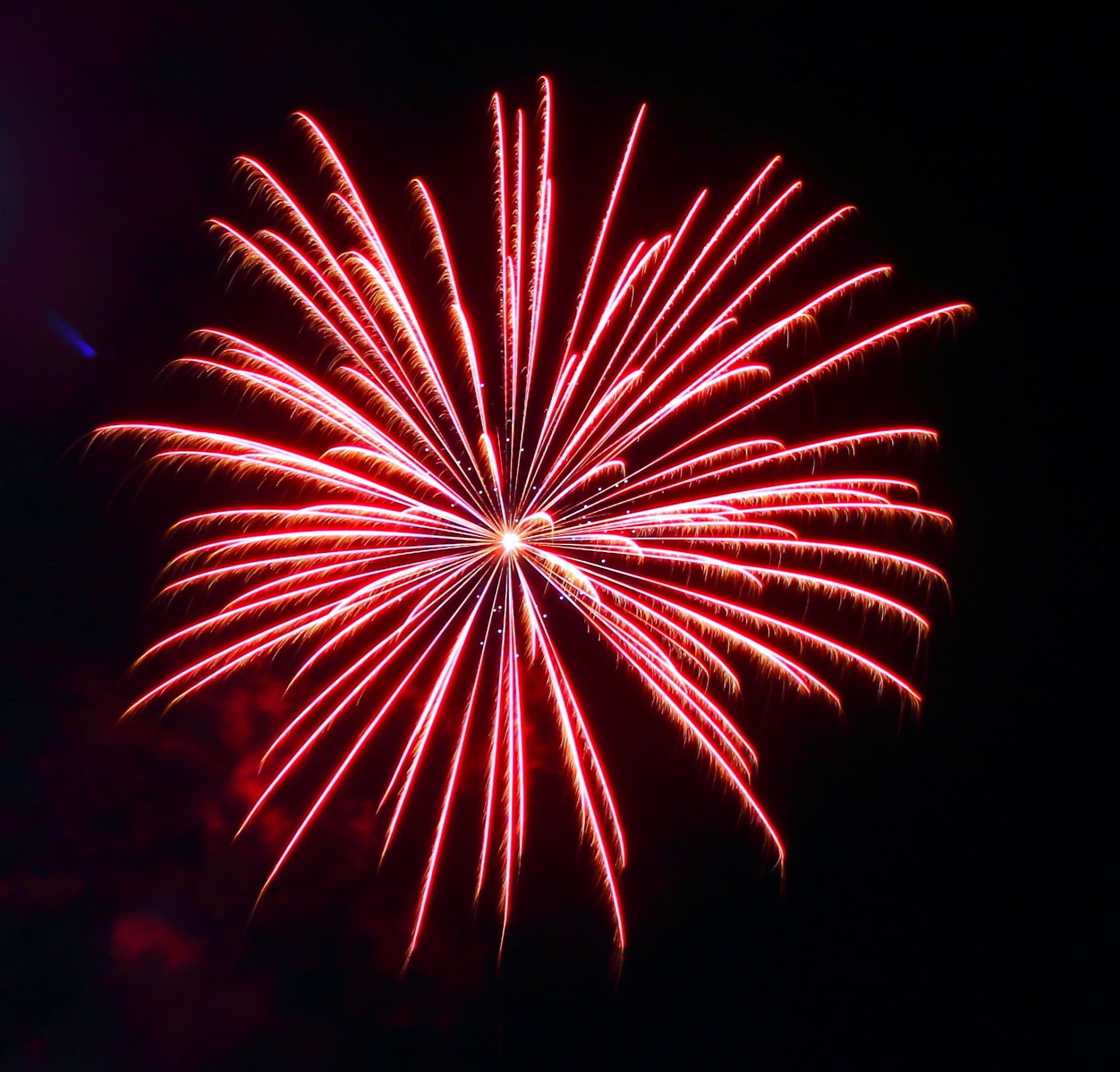 A red fireworks display in the night sky