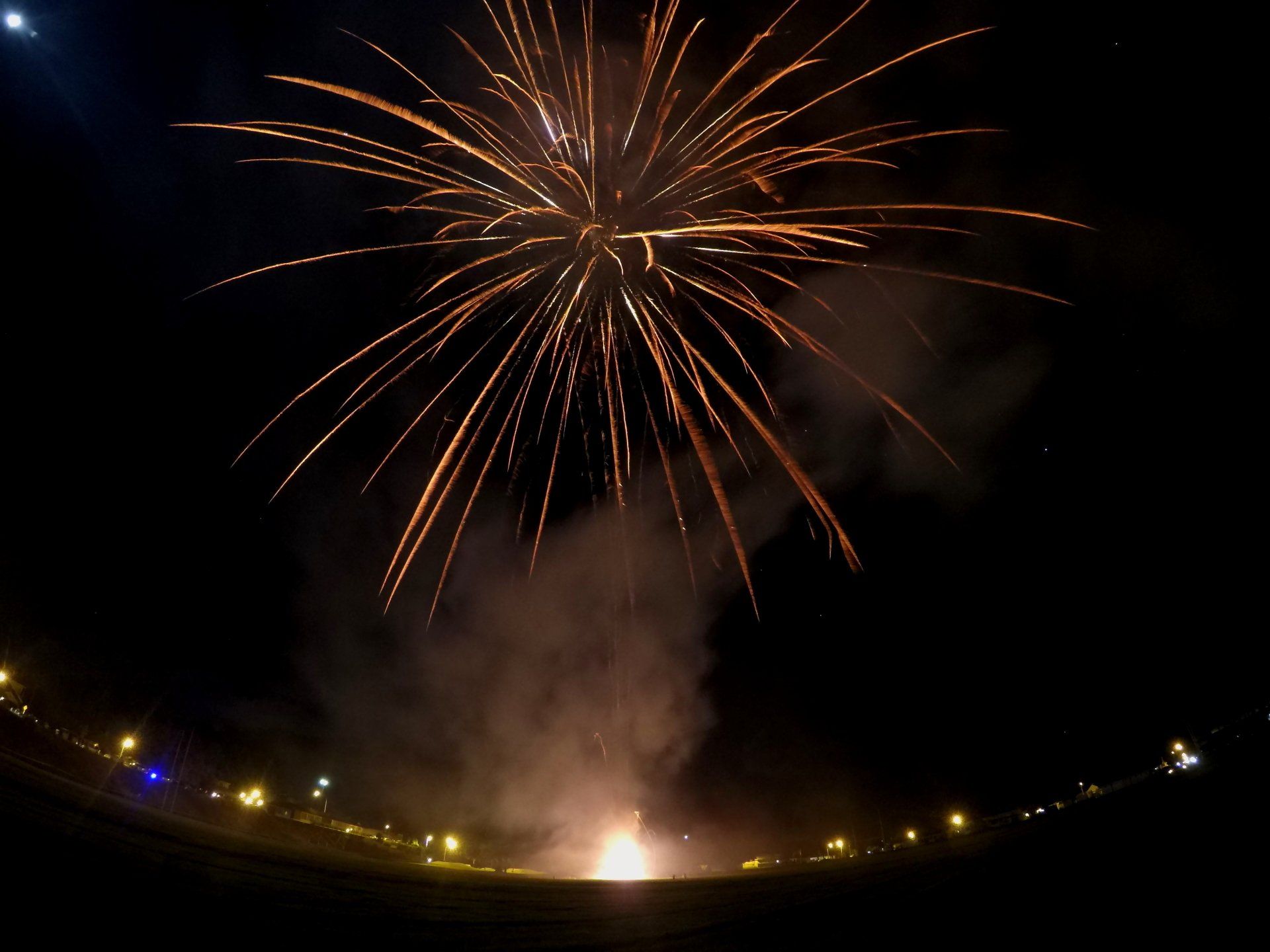 A fireworks display is going off in the night sky