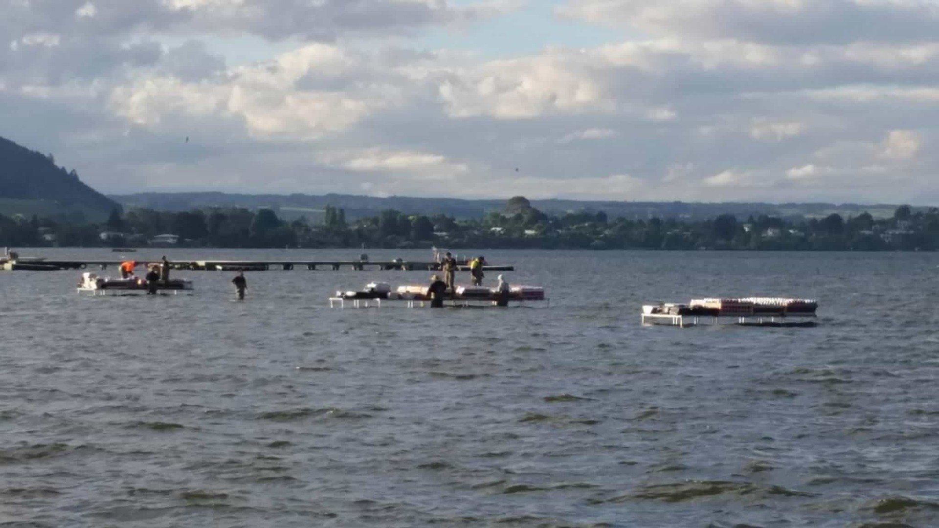 A group of people are floating on rafts in the water.