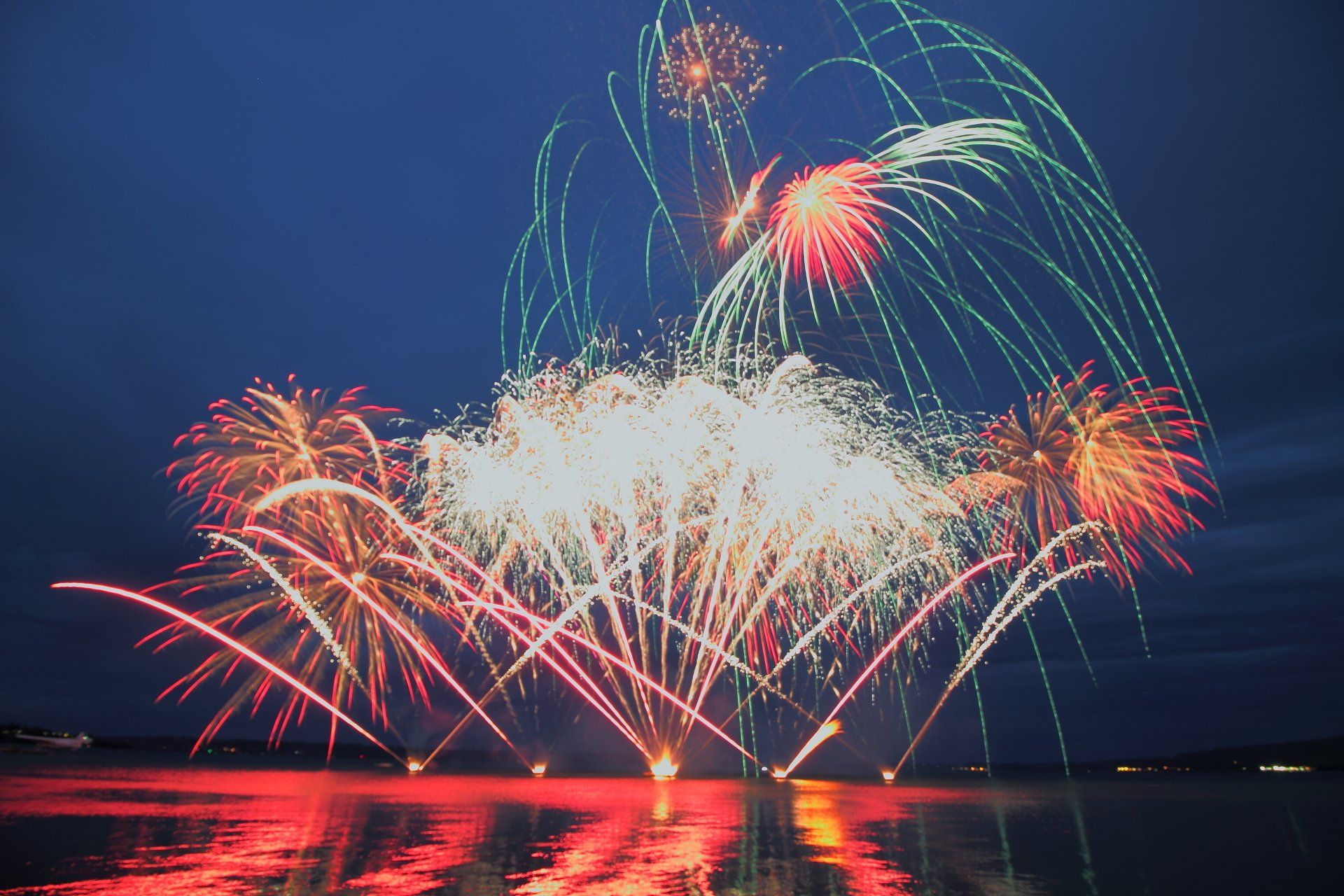 Fireworks are displayed over a body of water over Lake Rotorua 