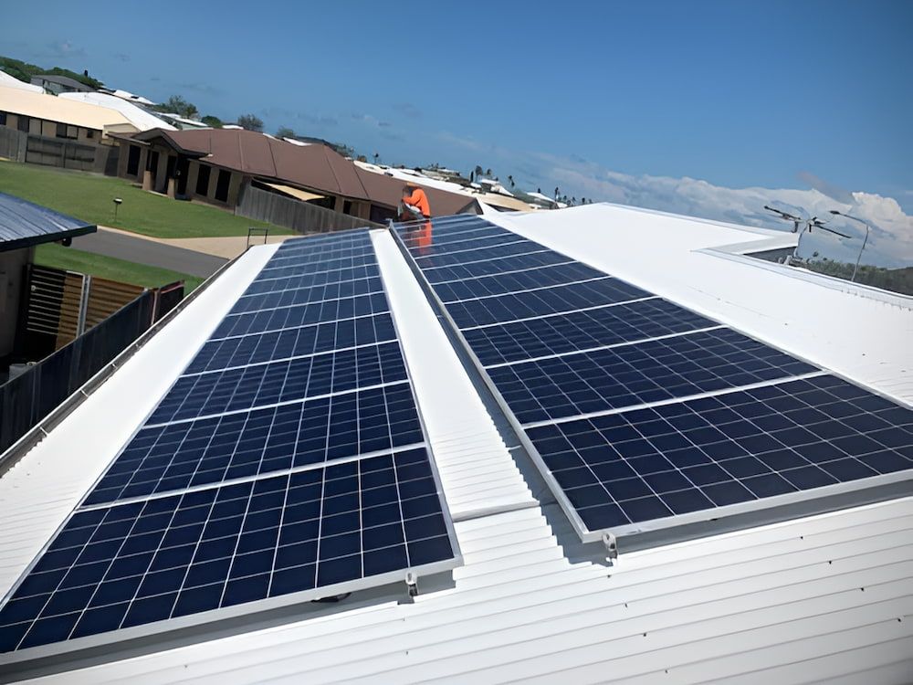 A Row Of Solar Panels On The Roof Of A Building — Levi's Electrics in Gladstone, QLD