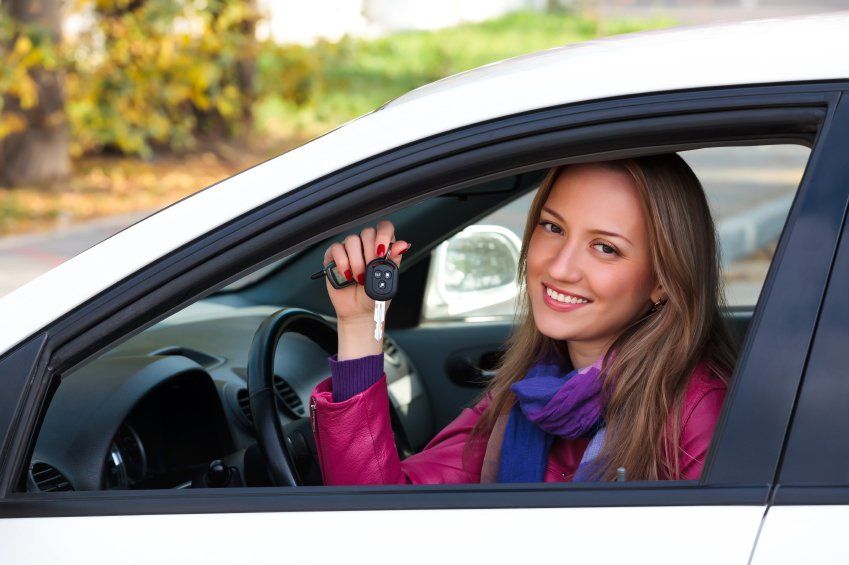 Woman sitting in driver seat of her car