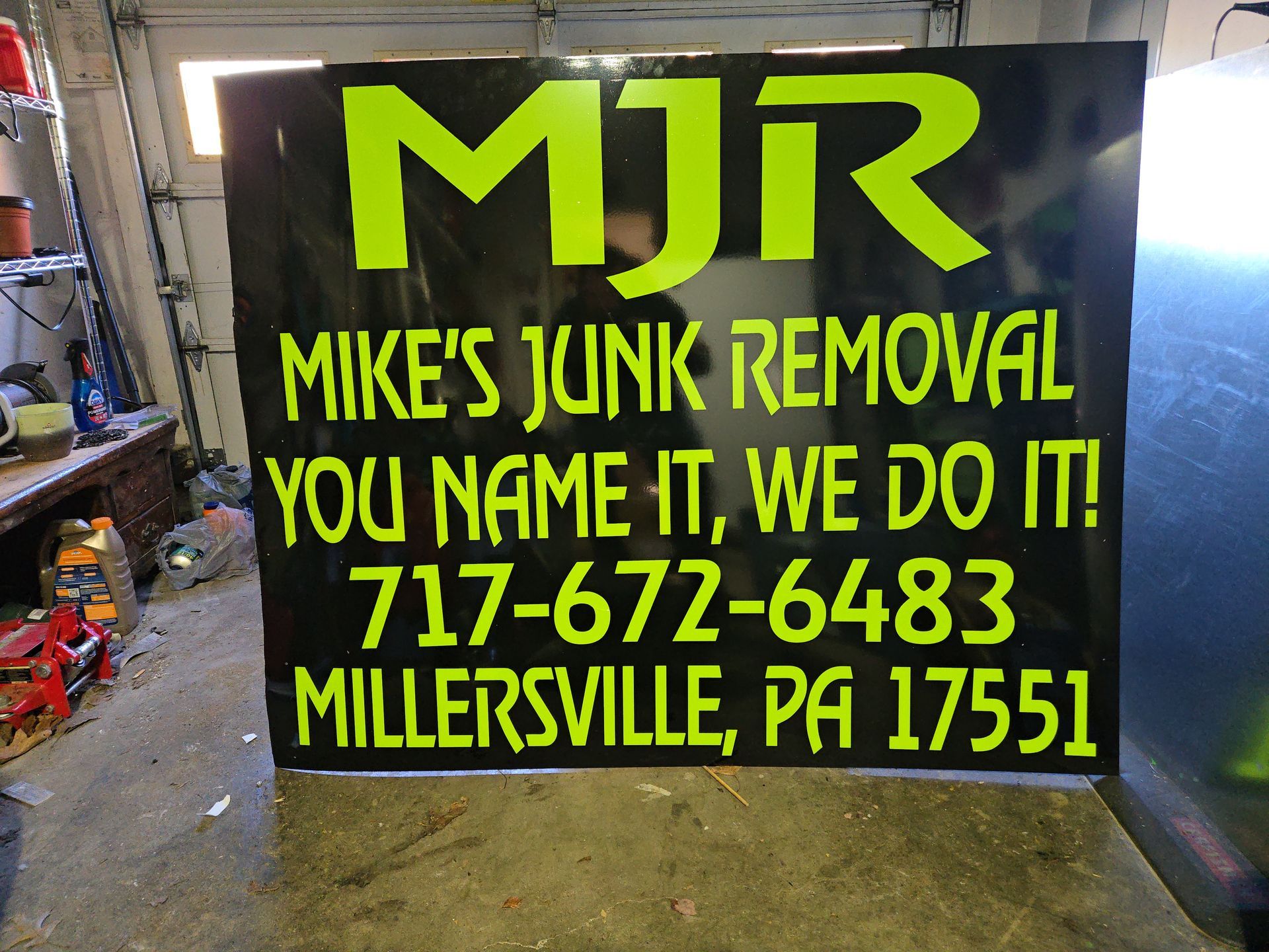 Black sign with neon green text. 
