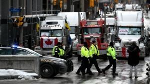 Police officers patrol on foot along Albert Street as a protest against COVID-19 restrictions that has been marked by gridlock and the sound of truck horns reaches its 14th day