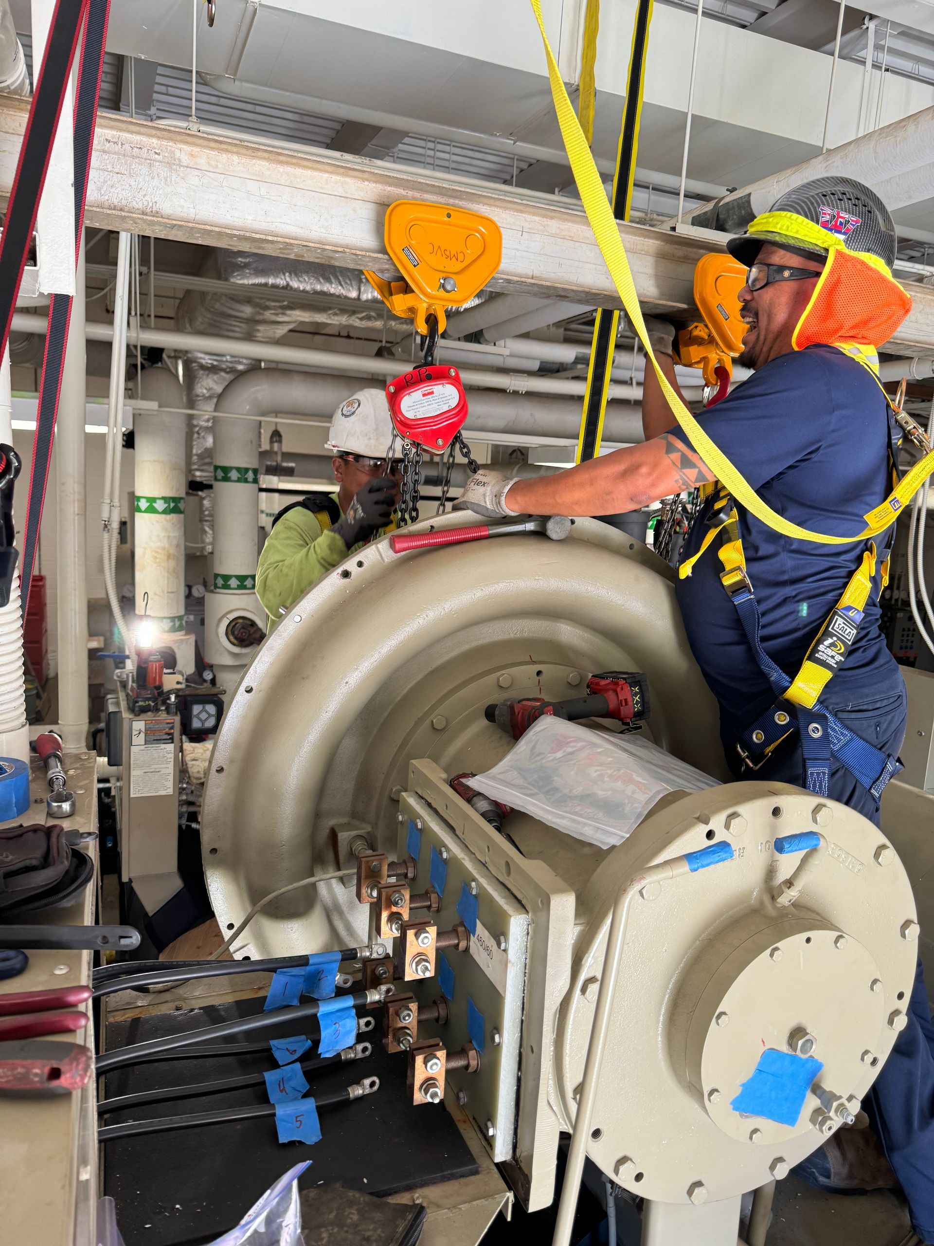 Industrial plant interior with large metal pipes, valves, and equipment under a high ceiling Industrial plant interior with large metal pipes, valves, and equipment under a high ceiling