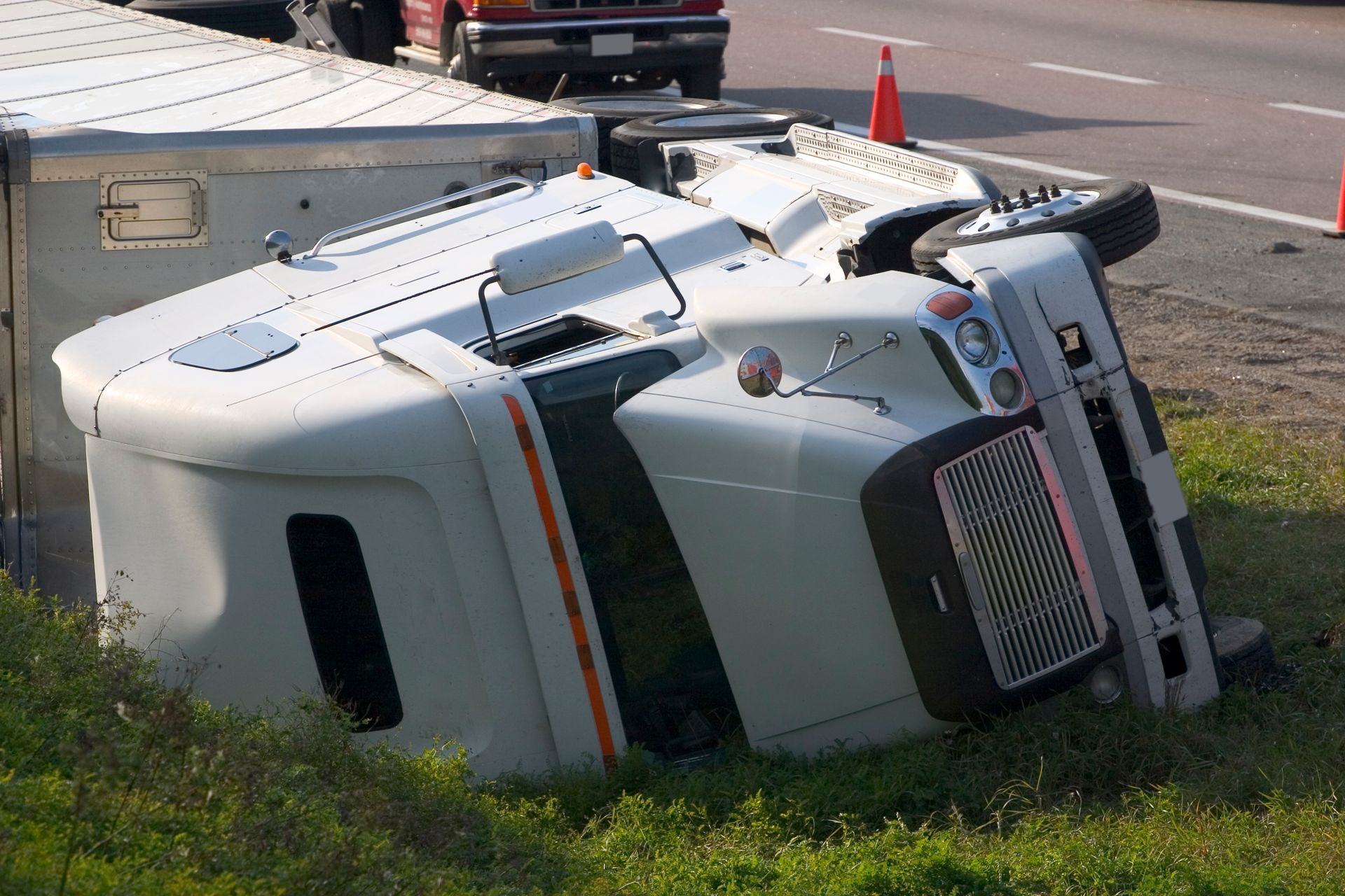 Picture of a truck crash on the shoulder of the freeway.