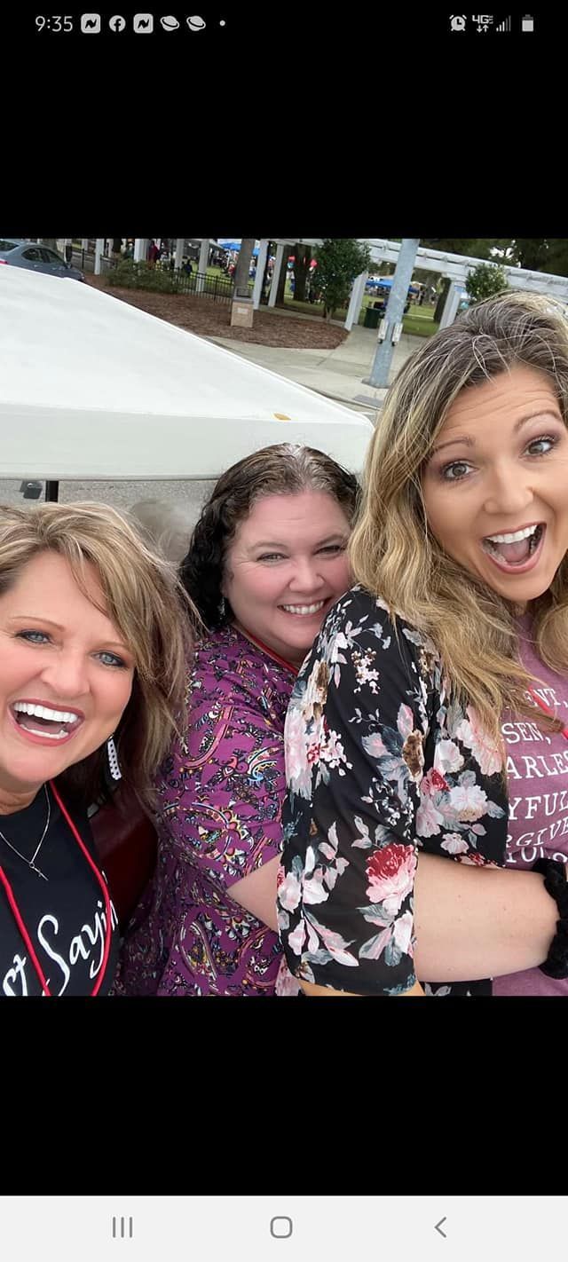 A person is holding a pineapple in a bag in a grocery store.