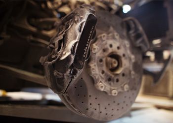 A close up of a brake caliper on a car.