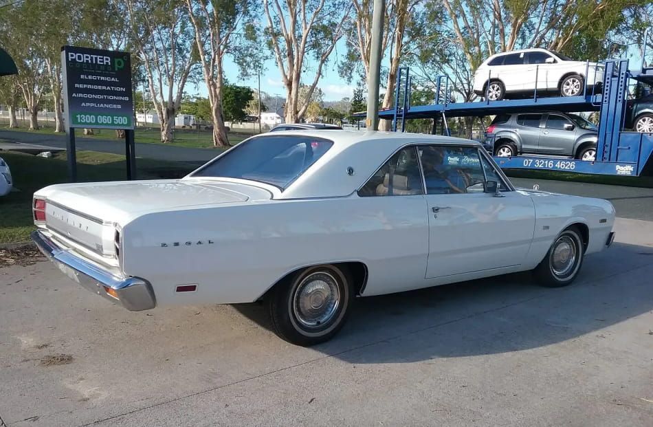 A White Car Is Parked On The Side Of The Road Next To A Truck — Proserpine Smash Repairs & Restorations In Proserpine, QLD