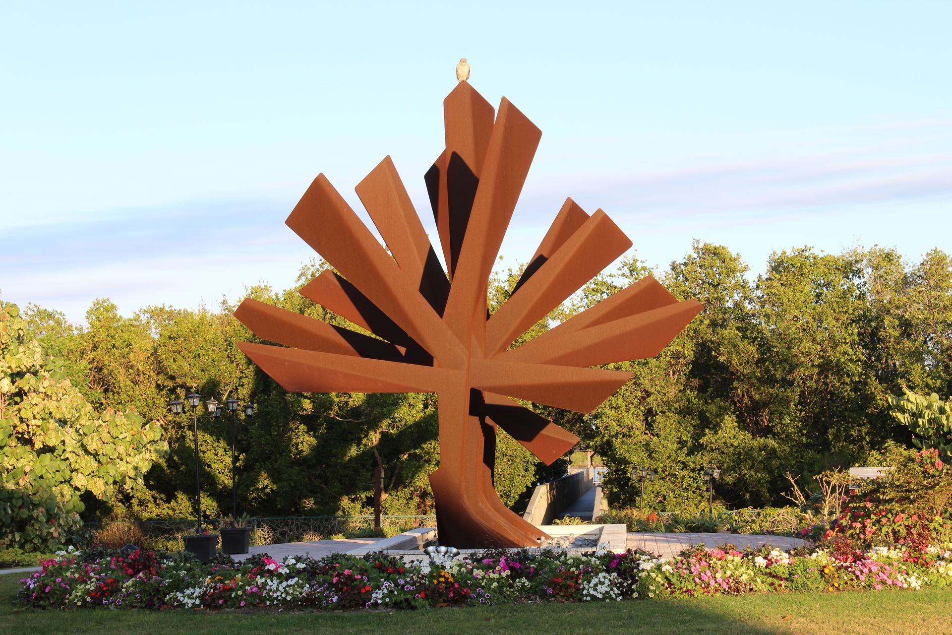 Flamingo Flower Sculptures flank the steel palm monument sculpture
