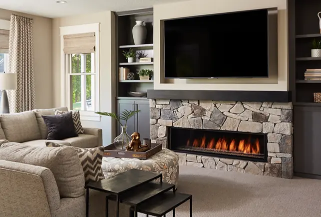 A living room with a fireplace and a flat screen tv.