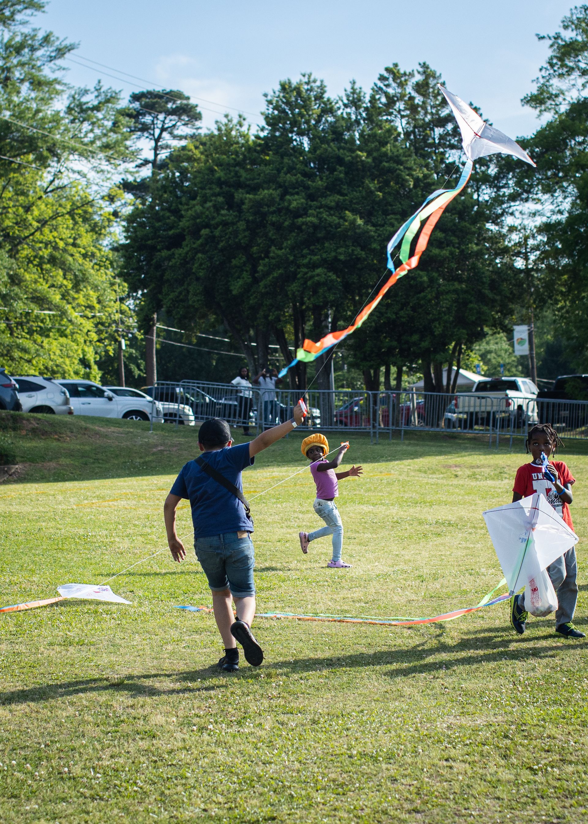 A group of children are flying kites in a park.