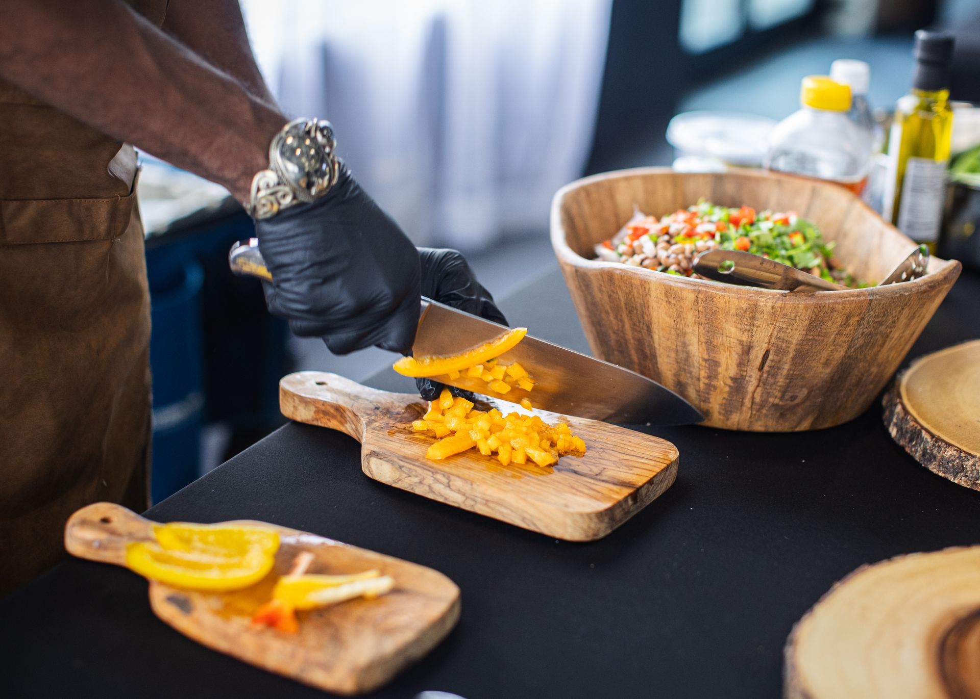 A person is cutting vegetables on a wooden cutting board.