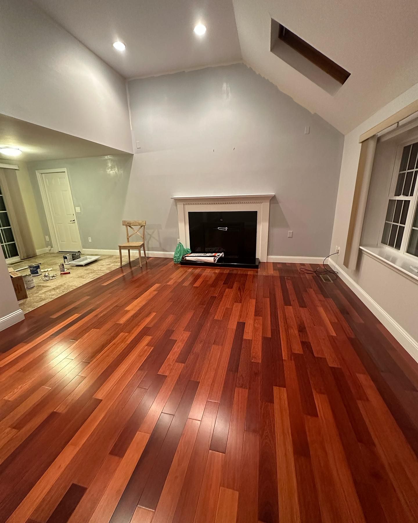 A living room with hardwood floors and a fireplace.
