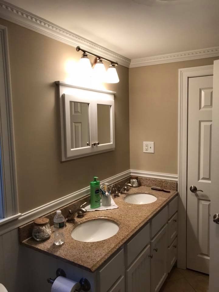 A bathroom with two sinks and a mirror