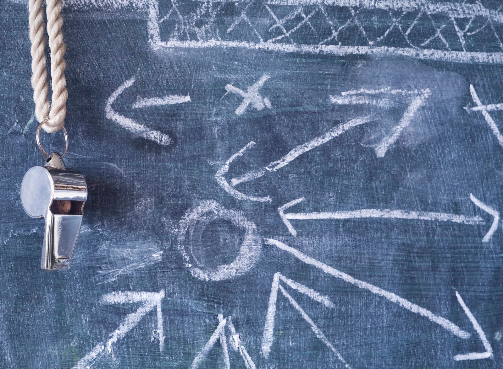 Whistle hanging from blackboard