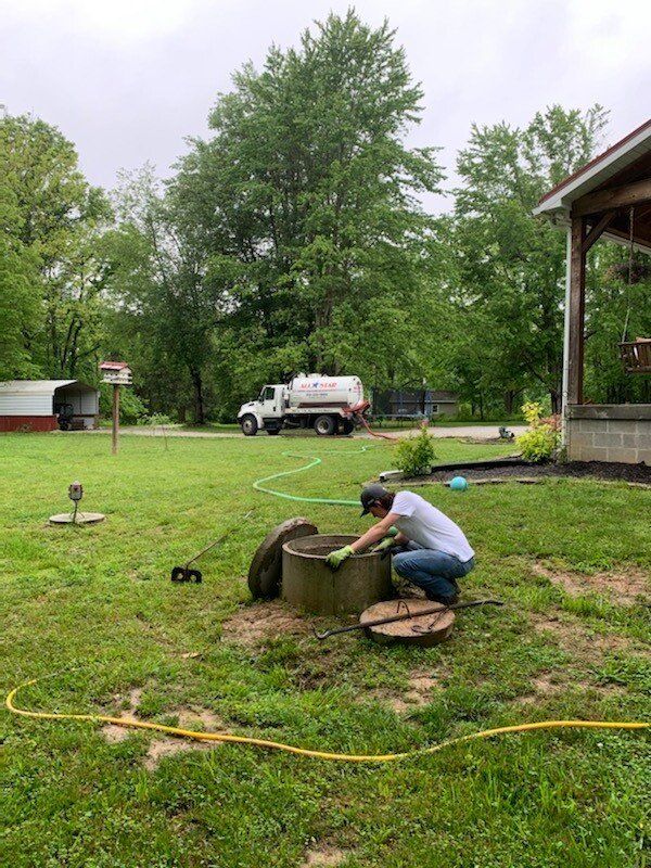 Man Checking Septic Hole | Terre Haute, IN | All Star Sanitation Inc.