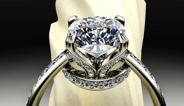 A diamond ring is sitting on a white cloth