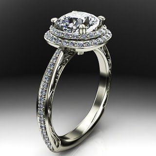 A white gold ring with a diamond in the center