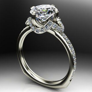 A white gold ring with a diamond in the center