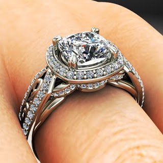 A close up of a diamond ring on a person 's finger