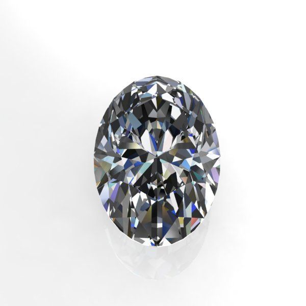 An oval diamond is sitting on a white surface.