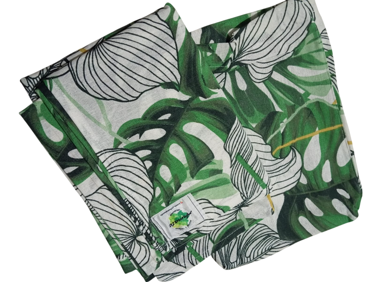 Tela estampada de hojas tropicales blancas y verdes dobladas.