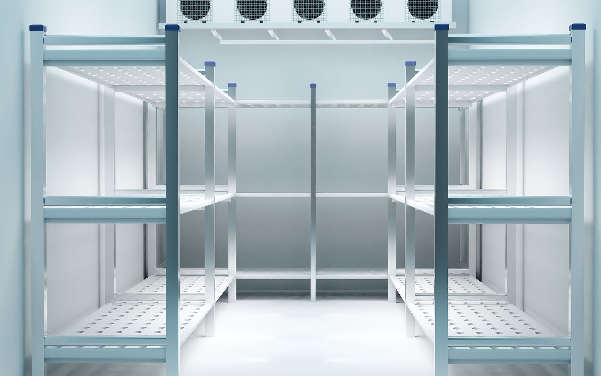 An empty refrigerator with stainless steel shelves and fans.