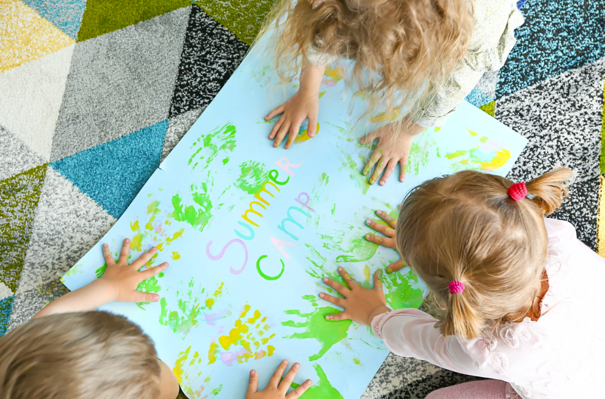 Children making handprints on a 