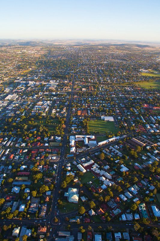 An aerial view of a city filled with lots of houses and trees.