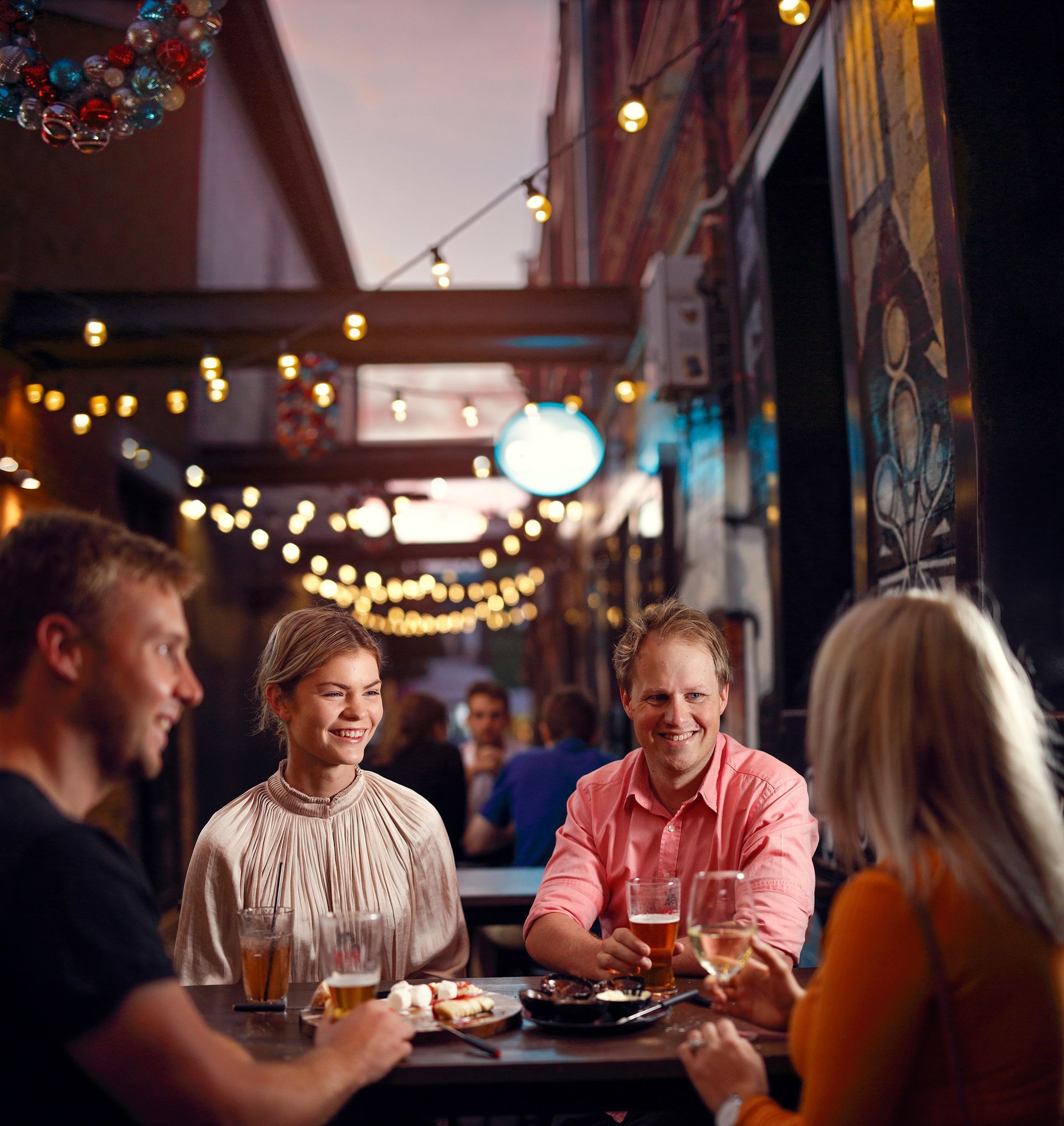 A group of people are sitting at a table in a restaurant